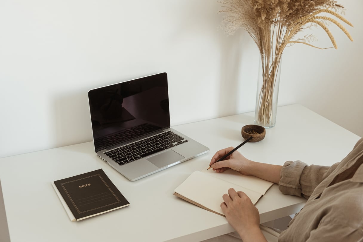 Woman Writing Notes in Home Office Desk 